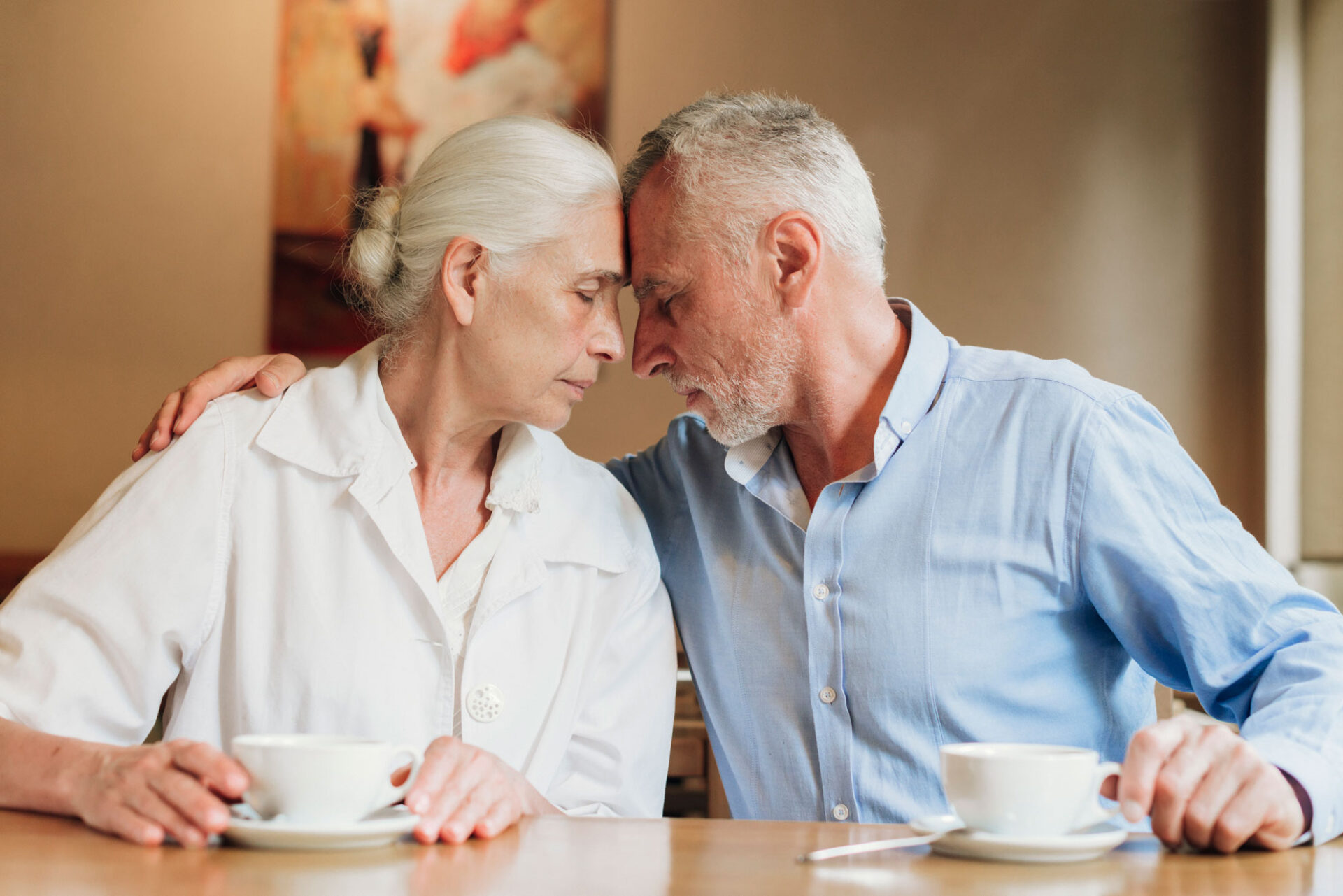 Senior couple sitting head to head over coffee, on the best dating sites for seniors