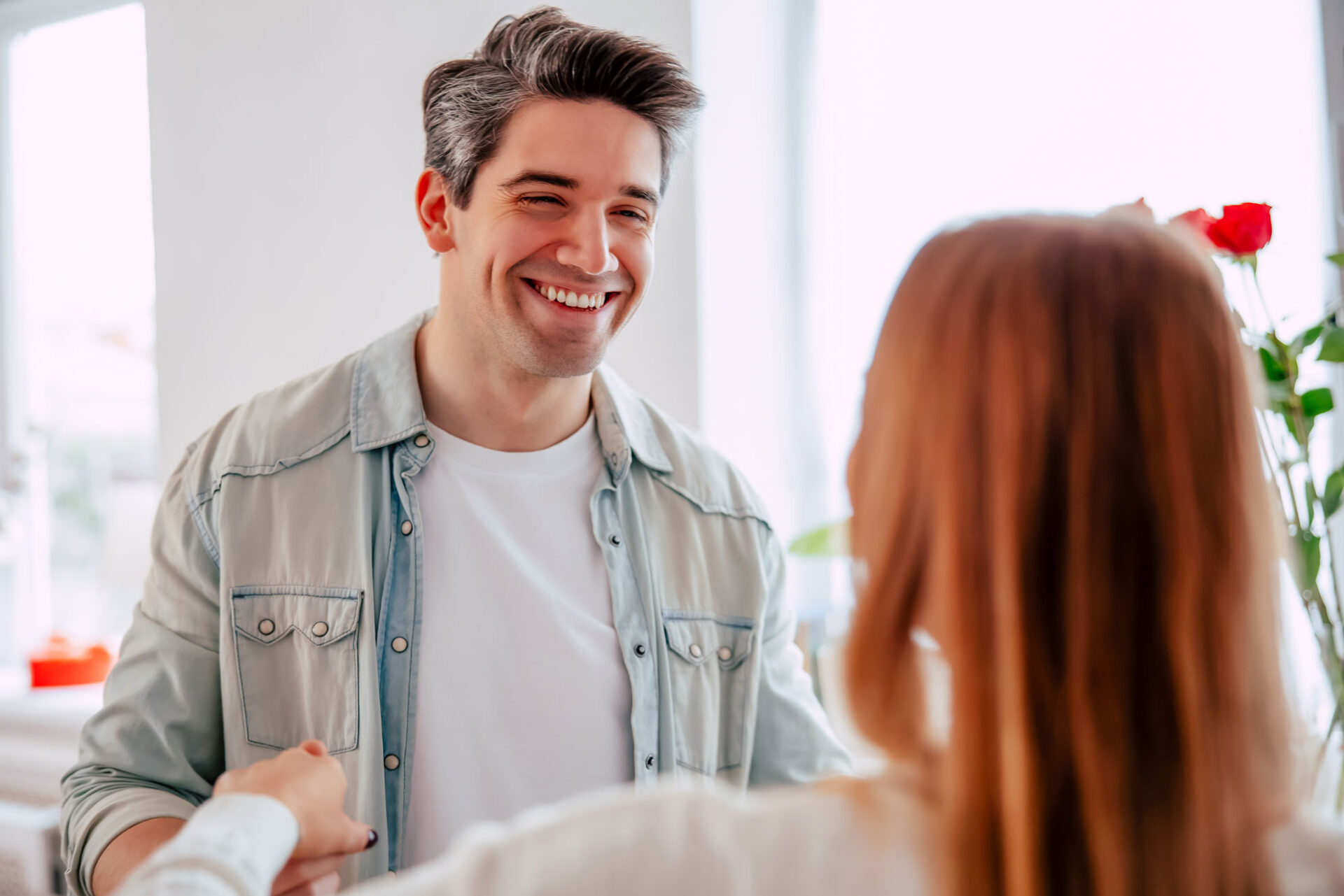 Man on a first date smiling at his date across a restaurant table after meeting on a free dating site