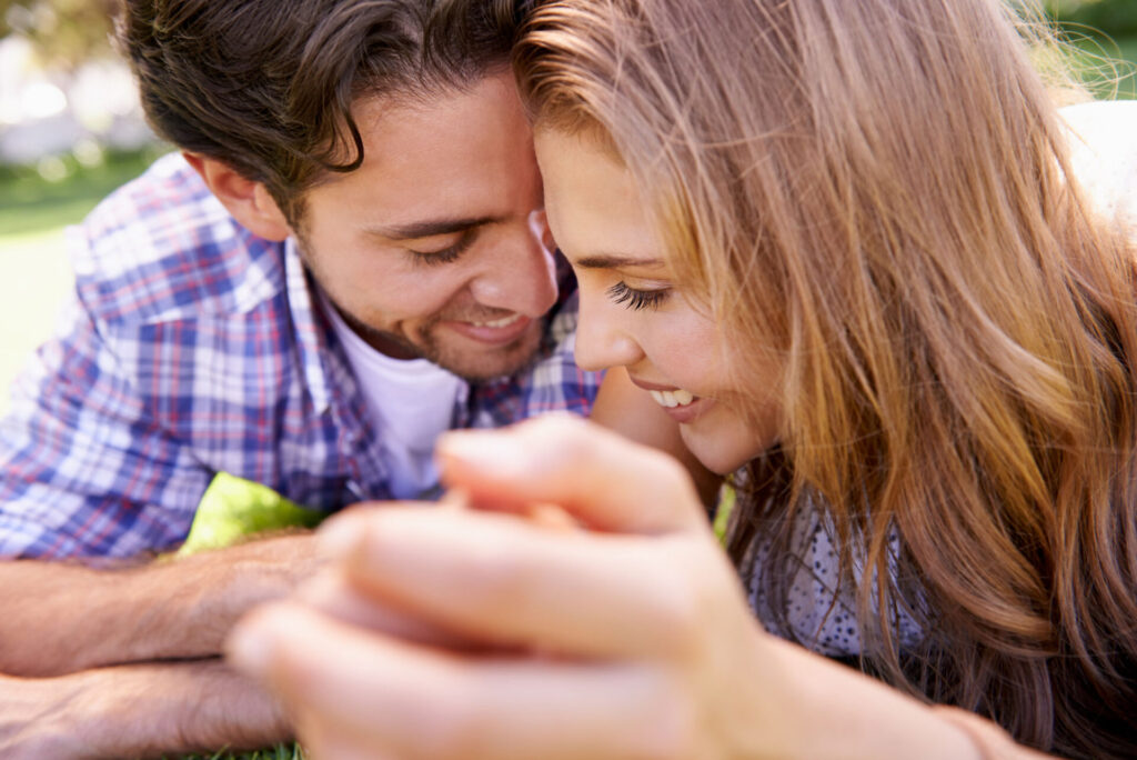 Couple smiling with their faces close together
