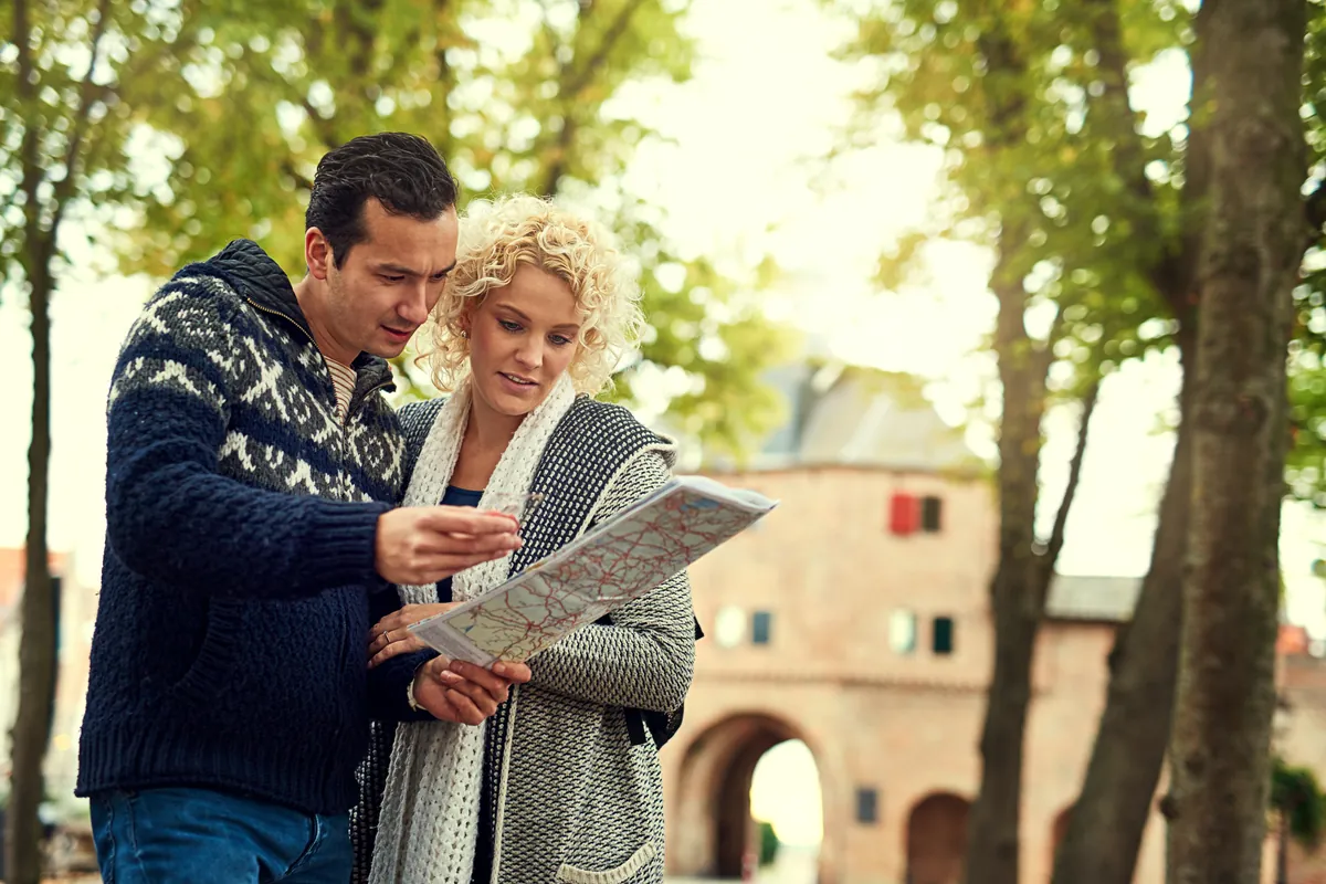 Couple reading a city map together while travelling