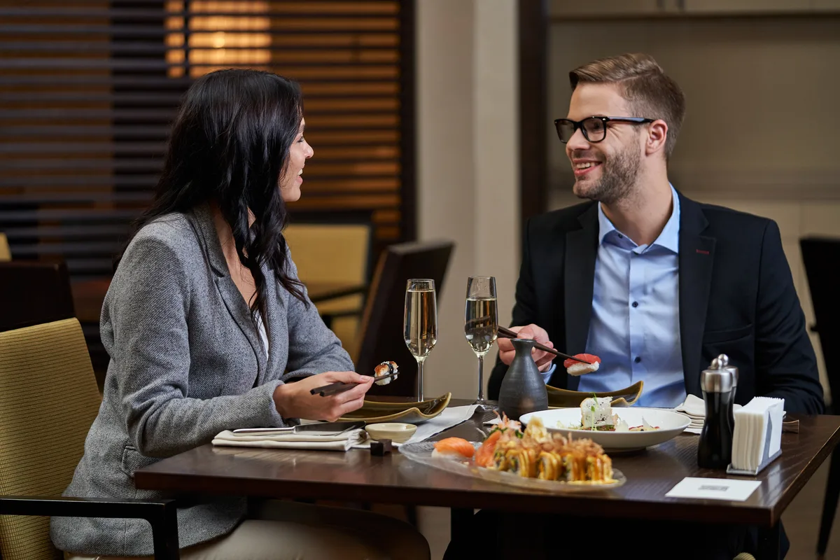 Two professionals talking over a lunch date in a restaurant
