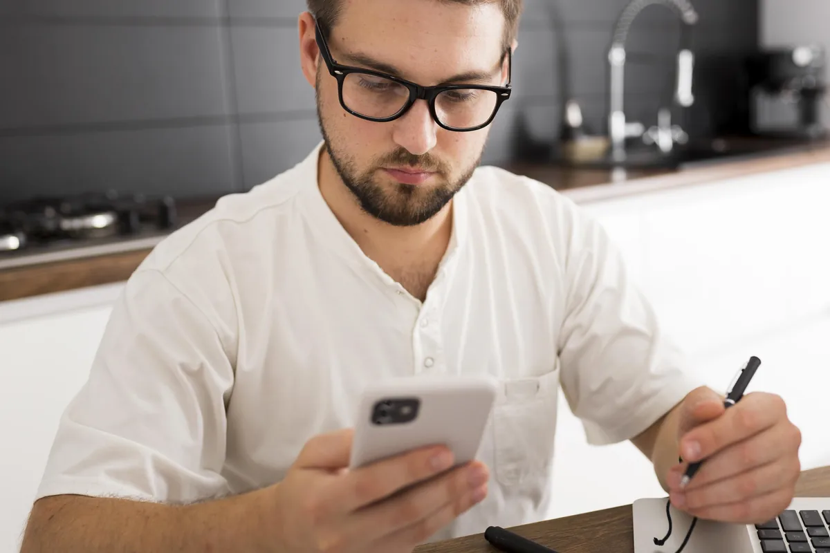 Man reading a profile on his phone to check whether Ukrainian dating sites are legitimate