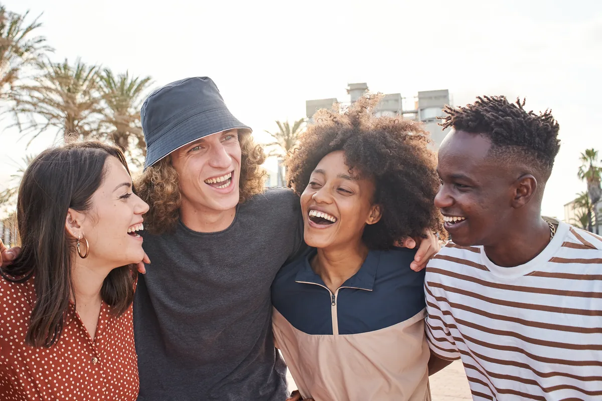 Group of young friends laughing together outdoors