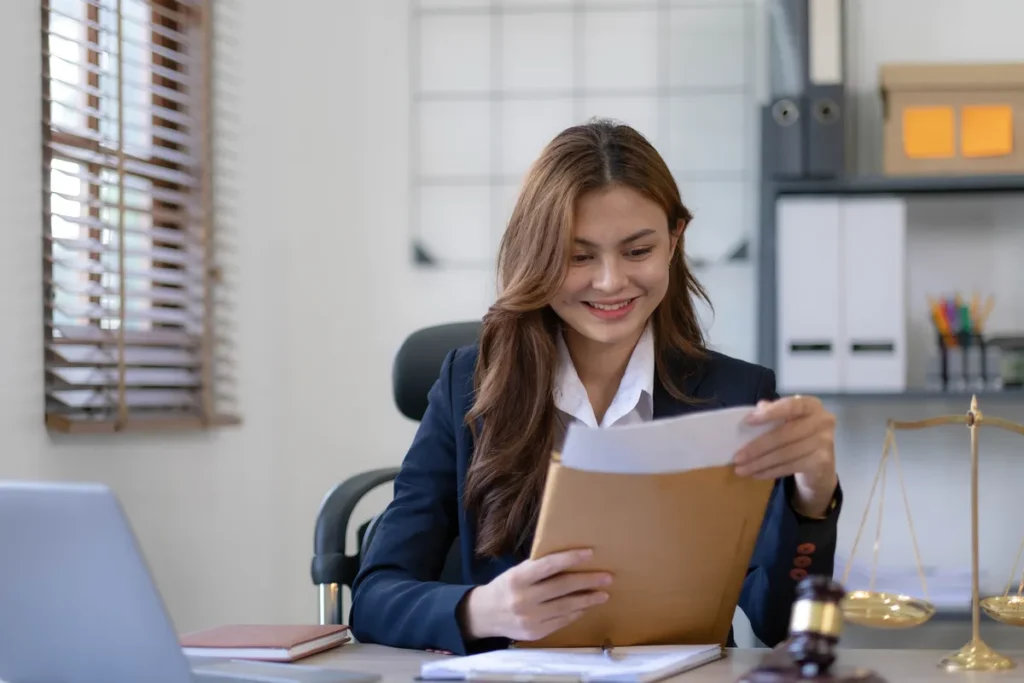 Attorney reviewing documents at her office desk