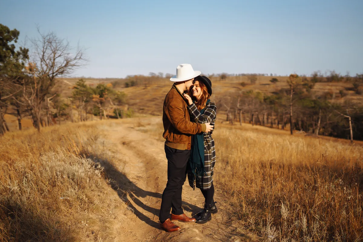 Couple embracing on a grassy hillside