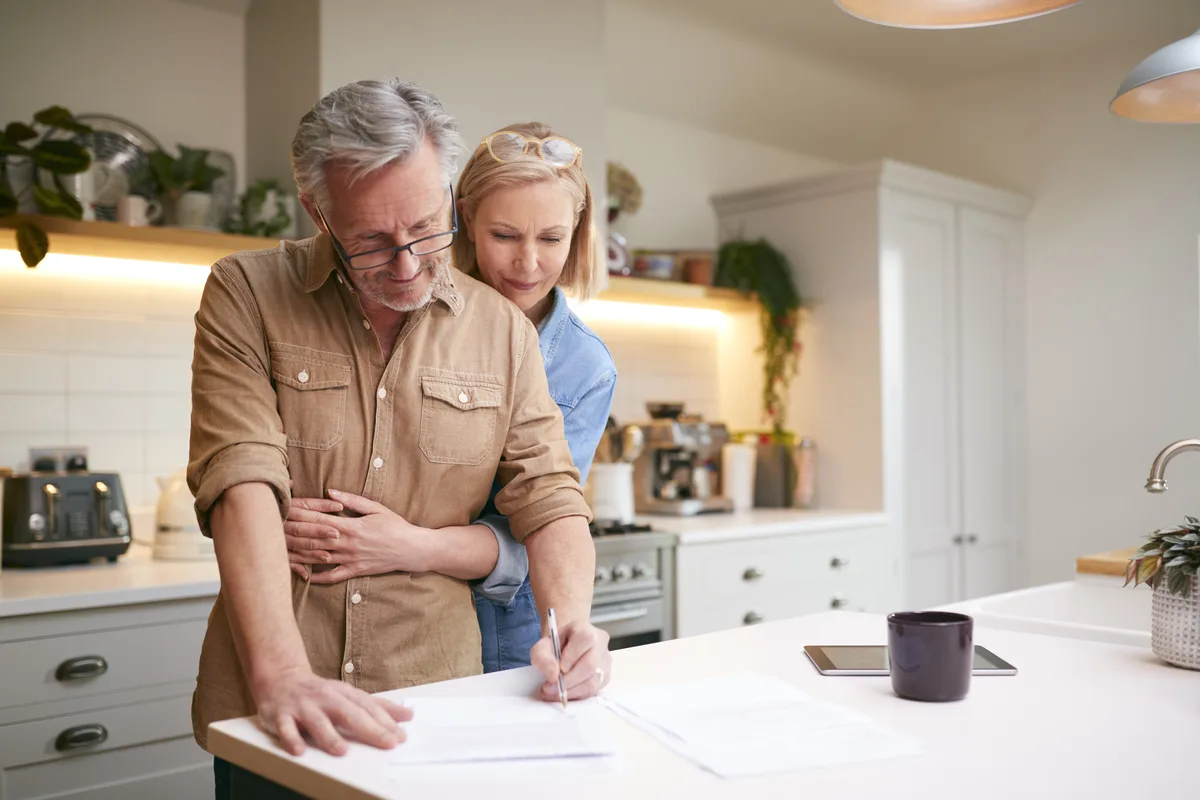 Couple going over paperwork together in their kitchen