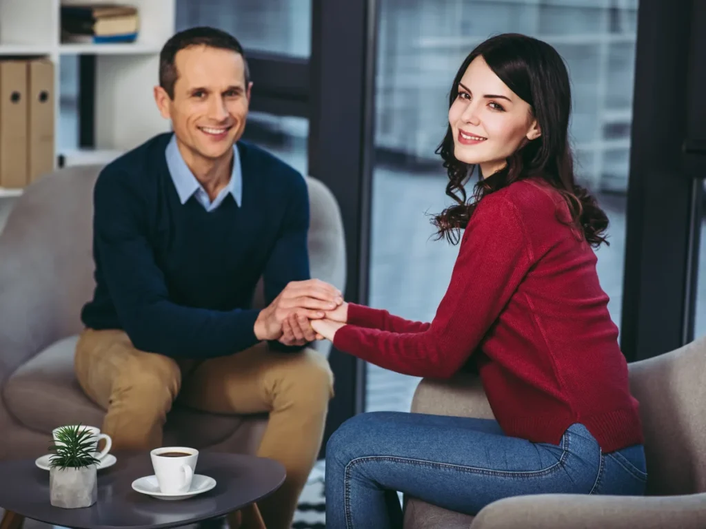 Couple holding hands during a meeting in an office