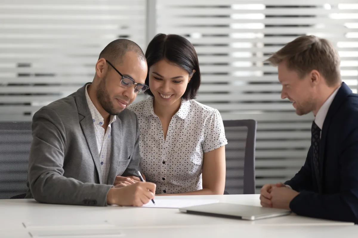 Couple meeting a lawyer in an office to go over documents