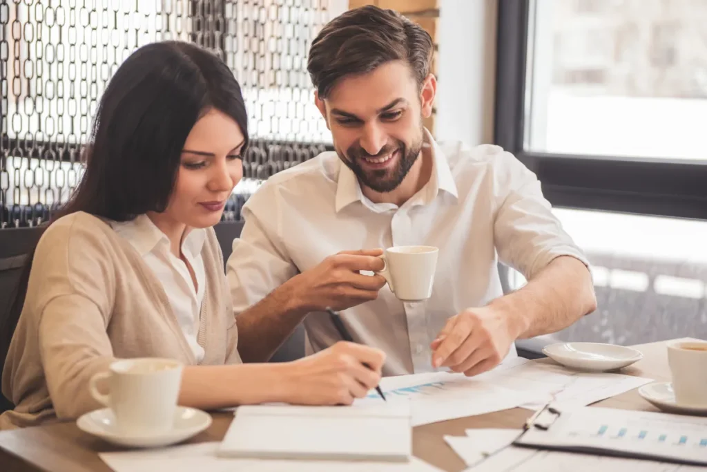 Couple going over paperwork together over coffee