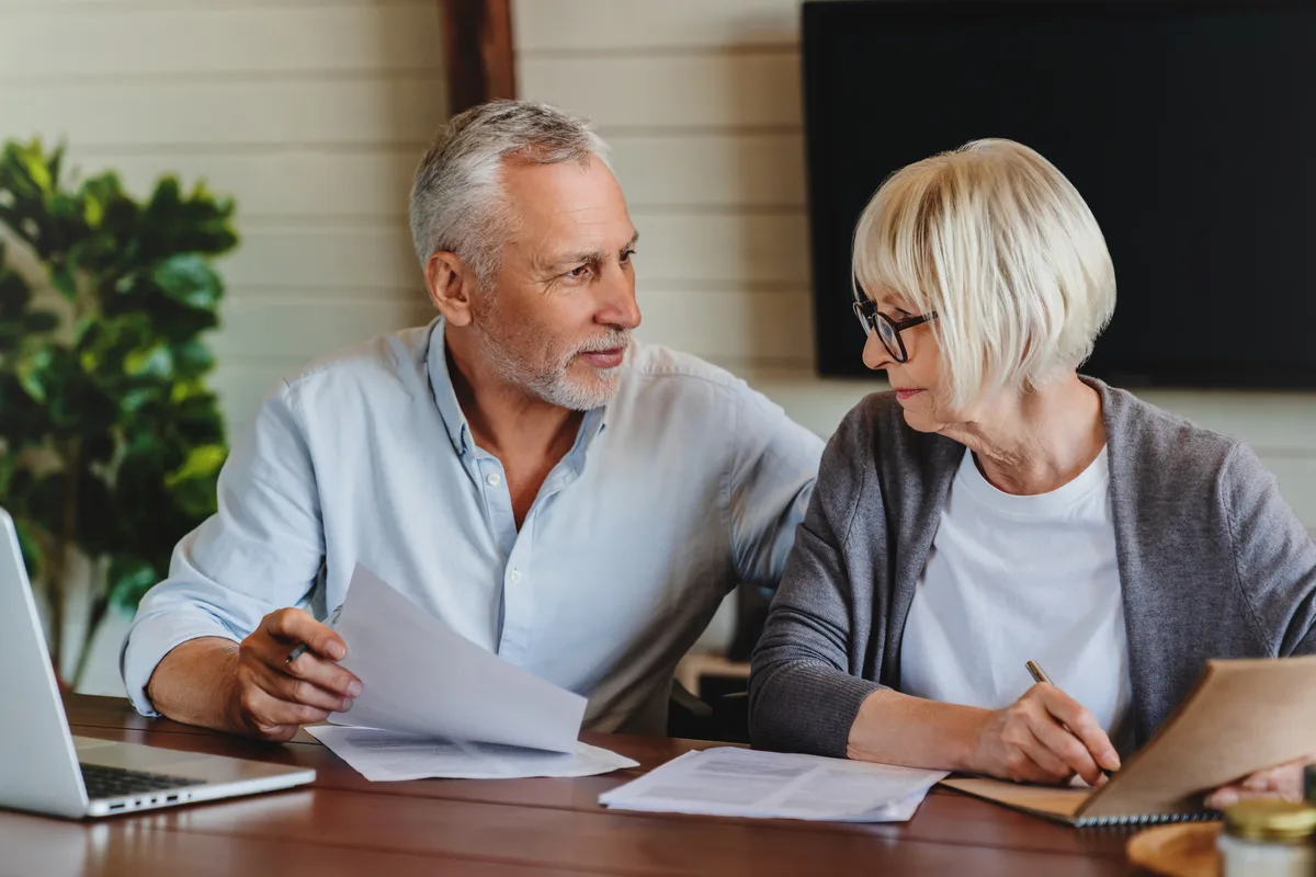 Mature couple reviewing documents together at a table